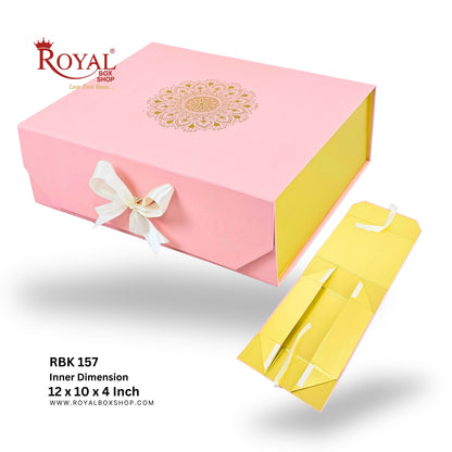 Pink and golden Royal Box Shop gift box packaging set, featuring a closed pink outer box with a white bow and gold mandala design, alongside an open yellow inner box, on a white background with product text.