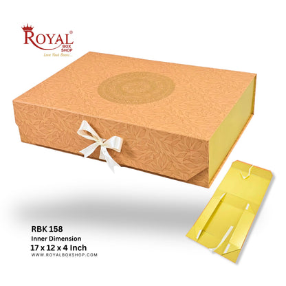 A gold-colored Royal Box Shop gift box with a white ribbon bow, shown alongside its yellow inner packaging and product specifications text on a white background.