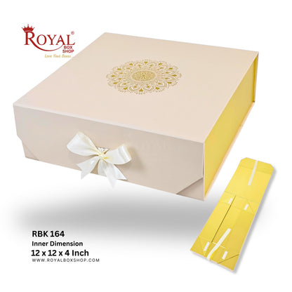 Royal Box Shop RBK 164 square gift box packaging set, featuring a beige outer box with a gold mandala design on top, a white ribbon bow, and a yellow inner dimension insert box shown beside it on a white background.
